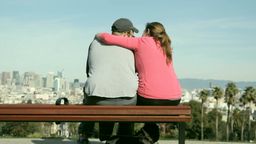 Answer couple, hugging, dog, bench, conversation, city
