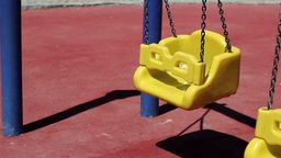 Answer swing, shadow, playground, chains, yellow, seat